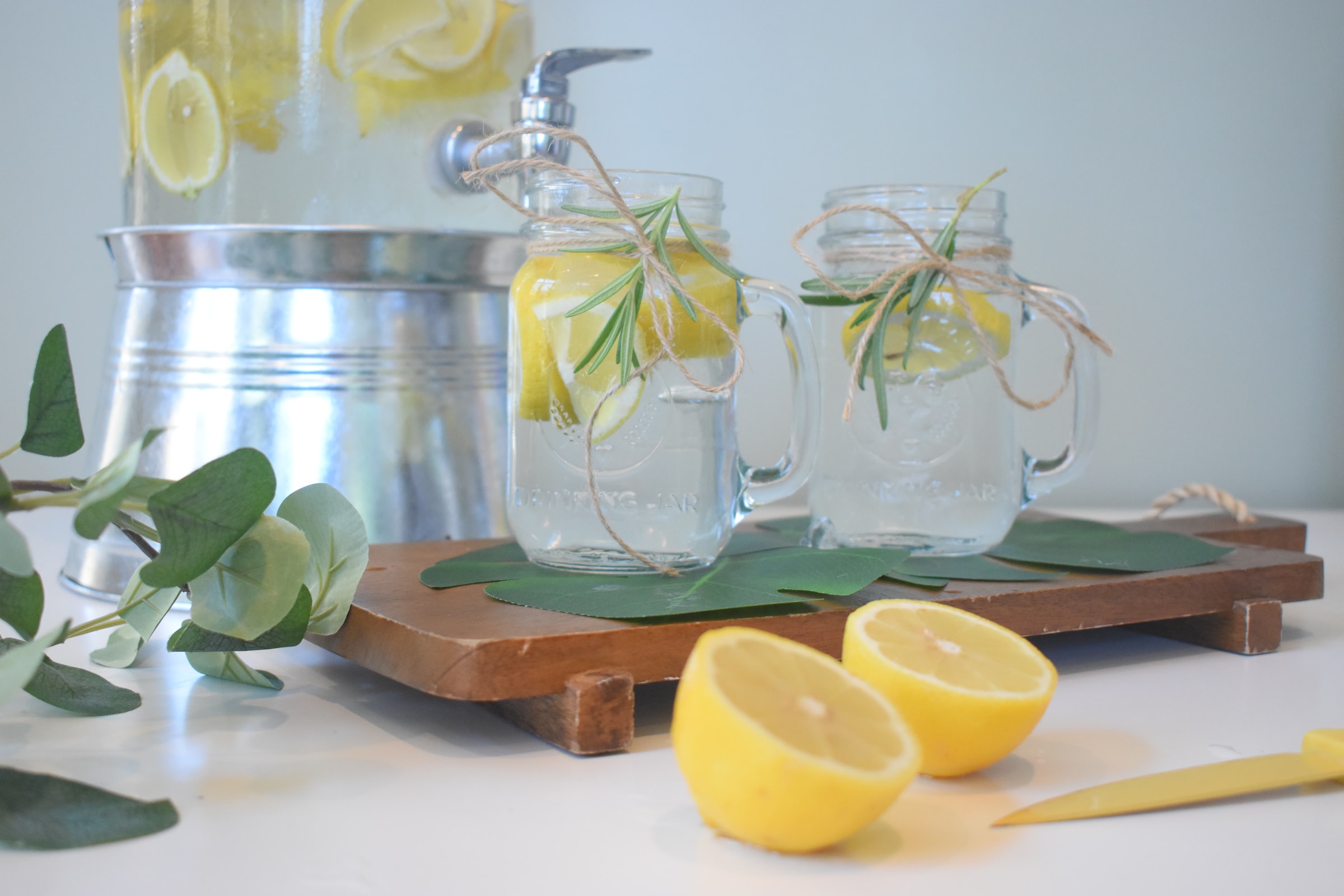 Water glasses & jug with lemon and herbs